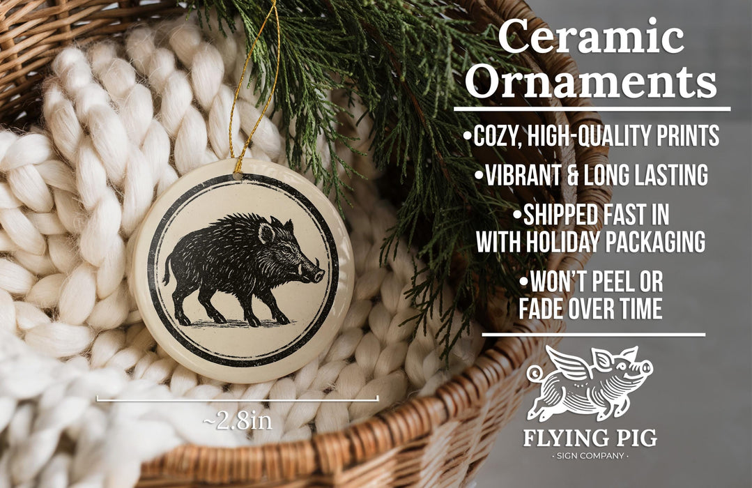 Ceramic ornaments, featuring a black and white illustration of a boar, are displayed in a woven basket.