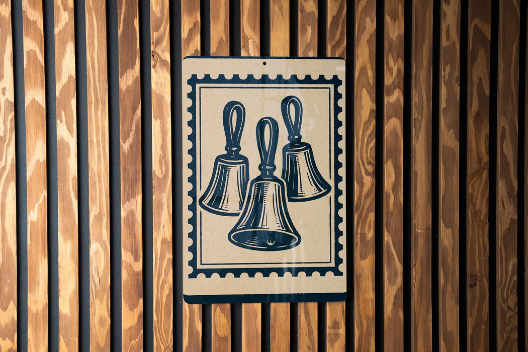 A sign with three bell-shaped illustrations is displayed on a wooden wall.