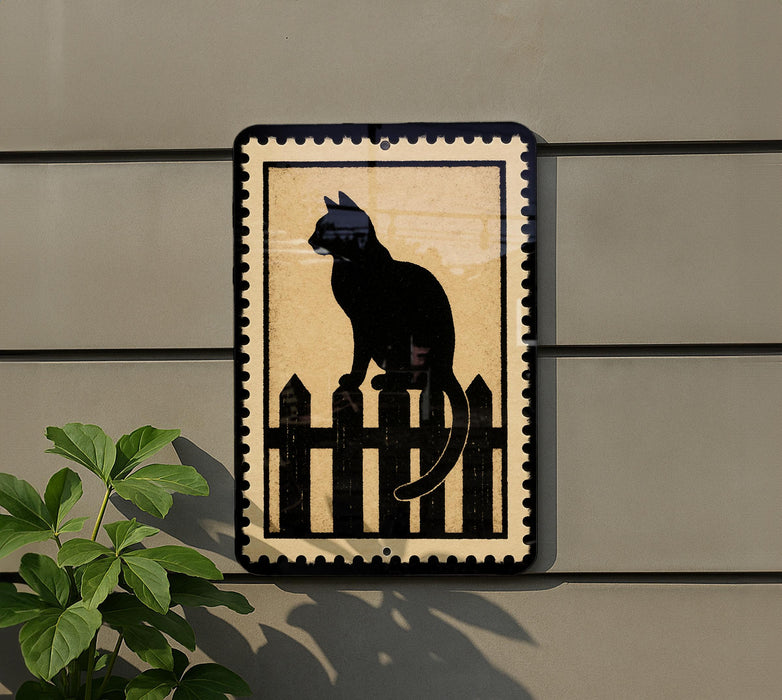 a black cat sitting on a wooden fence.