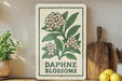 a sign with a floral design, a wooden cutting board, and some potted plants on a shelf.