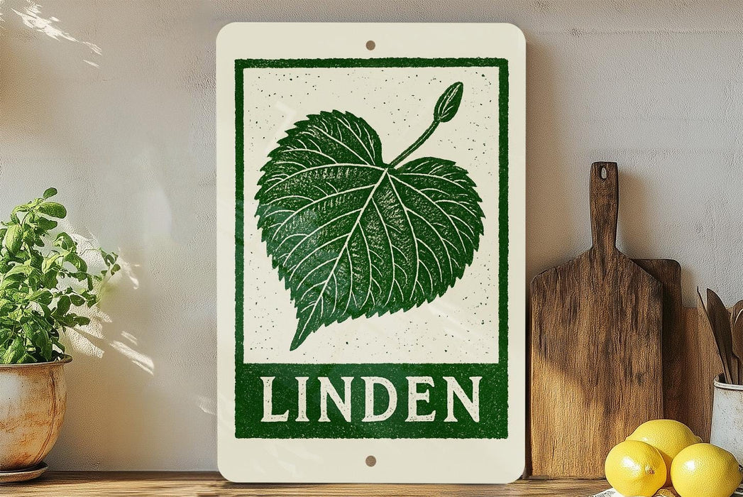 a sign with a green leaf design and the word "LINDEN" written on it, placed on a wooden surface next to a potted plant and a cutting board.