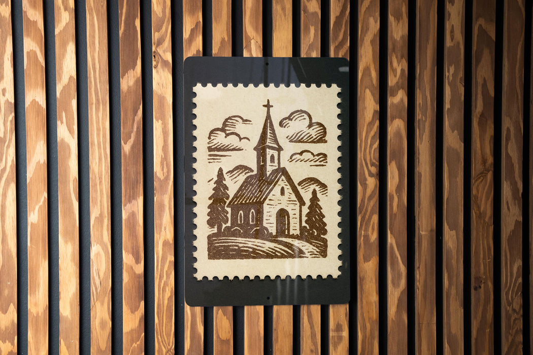 A church illustration on a postage stamp is displayed on a wooden wall.