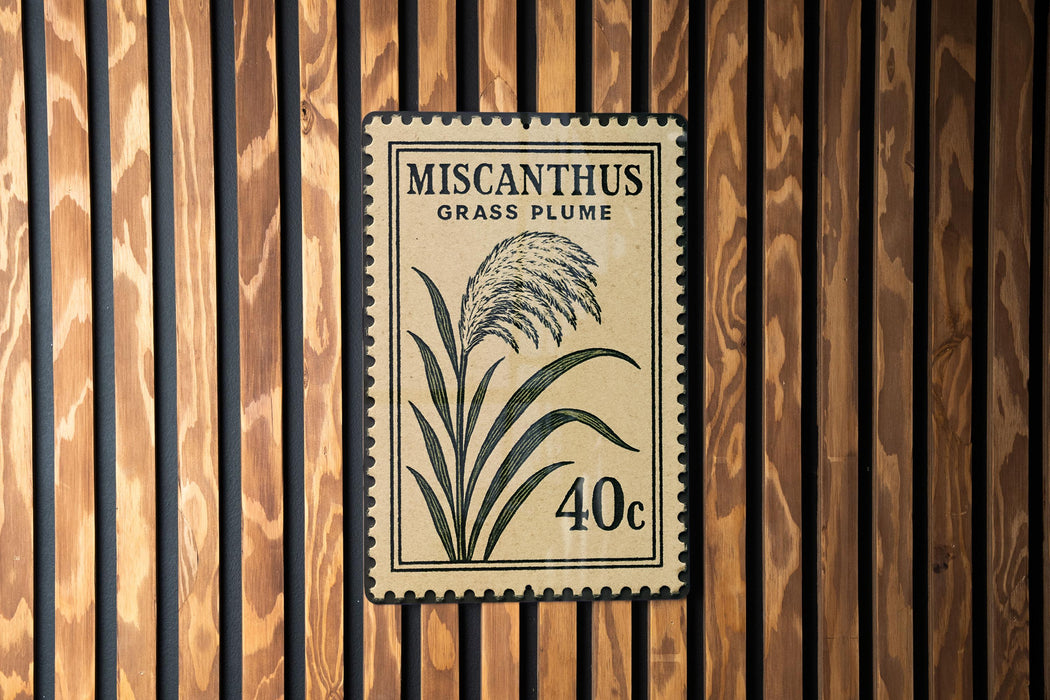 A 40 cent postage stamp featuring a grass plume design, mounted on a wooden wall.