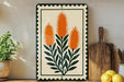a decorative piece with a floral design, placed on a wooden surface next to a wooden cutting board and a potted plant.