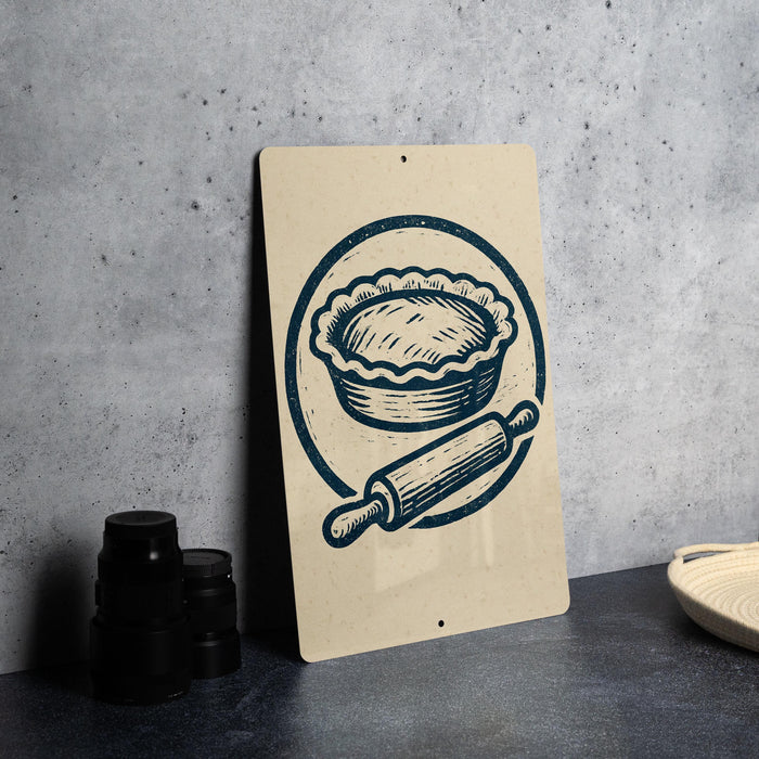 a sign with a pie and a rolling pin, along with some black containers on a countertop.