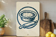 a kitchen scene with a pie, a rolling pin, and a wooden cutting board.