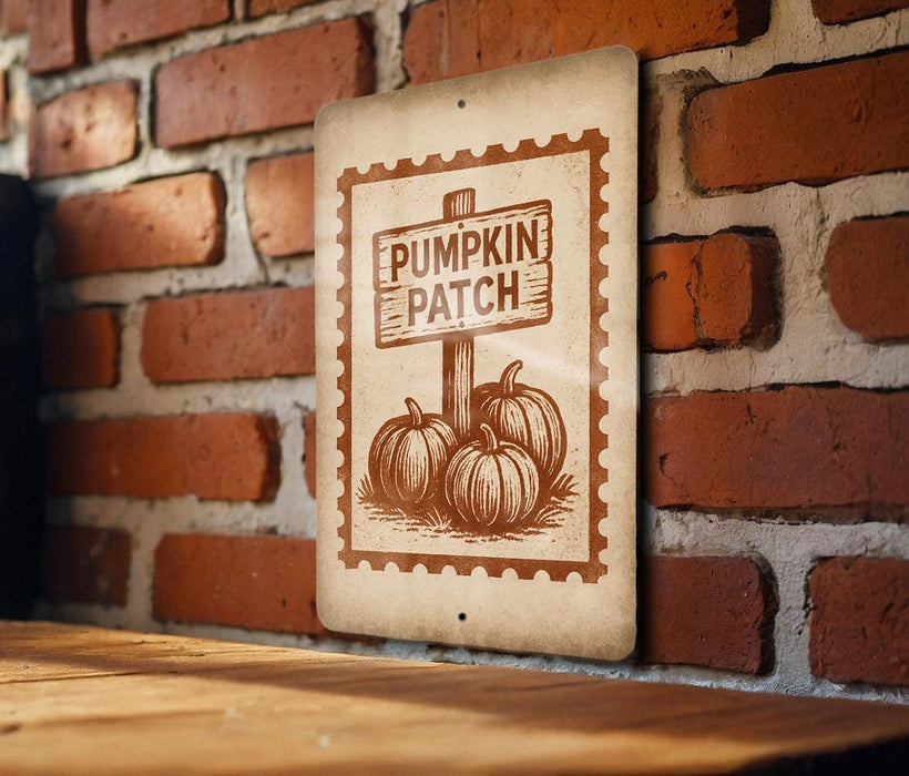 a sign that reads "Pumpkin Patch" with three pumpkins depicted on it, mounted on a brick wall.