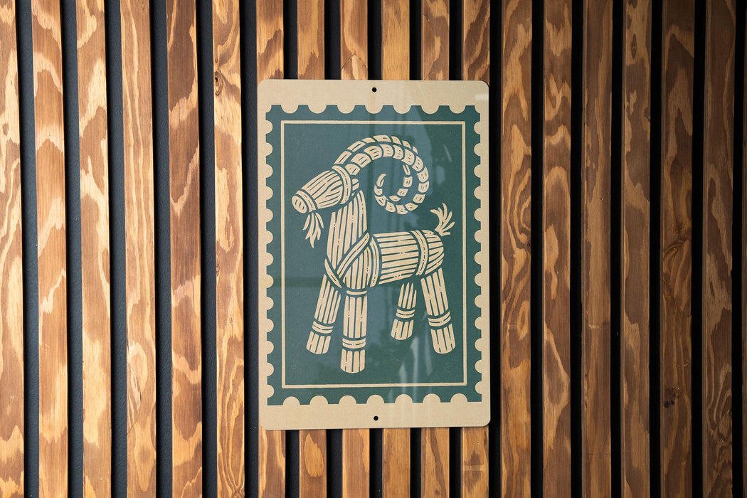 A wooden wall with a green and white sign featuring a stylized goat design.