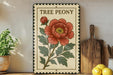 a decorative sign with a large red peony flower, placed on a wooden surface next to a wooden cutting board and a potted plant.