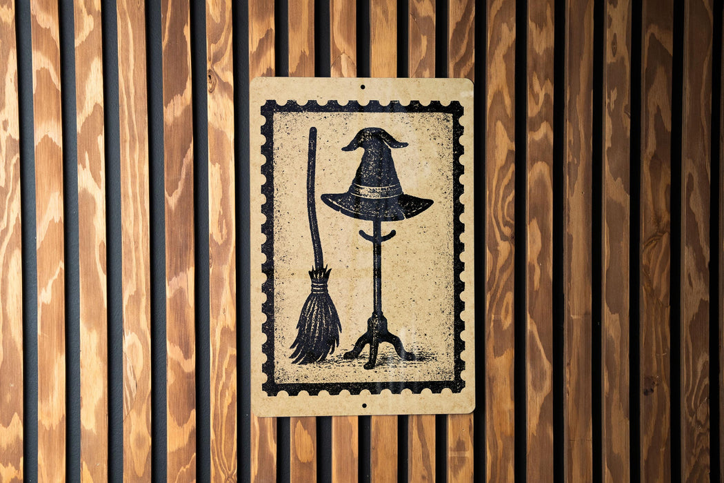 A black and white illustration of a witch's hat and broom is displayed on a wooden wall.