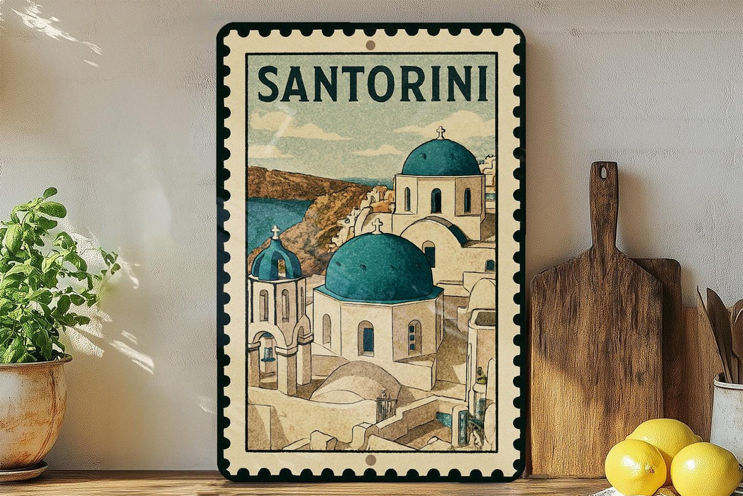 A framed illustration of Santorini, a Greek island, is displayed on a shelf next to a wooden cutting board and some potted plants.