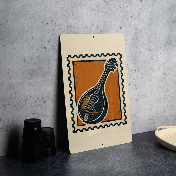 a framed print of a mandolin, which is a musical instrument, placed on a table.