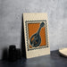 a framed print of a mandolin, which is a musical instrument, placed on a table.