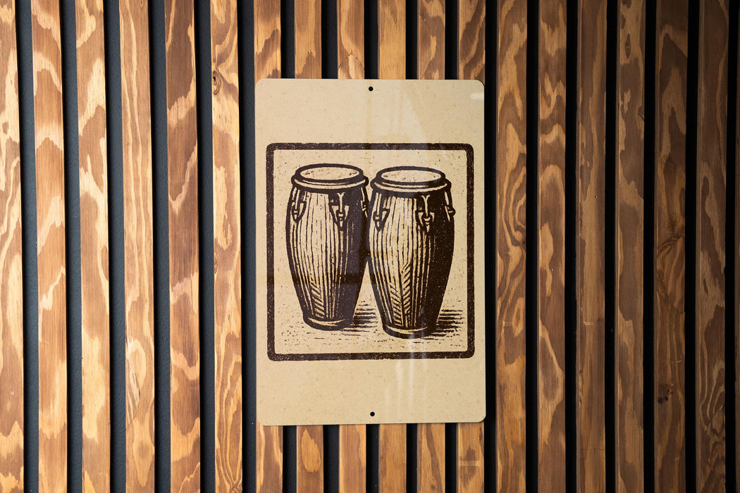 a sign with a black and white illustration of two drums mounted on a wooden wall.