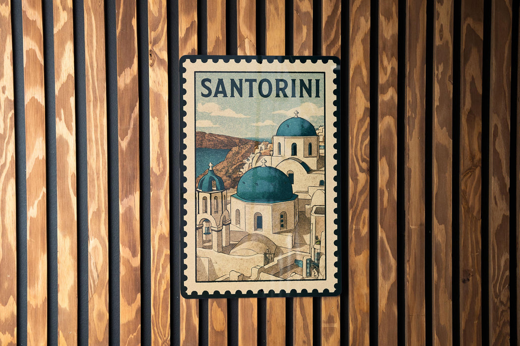 A vintage postage stamp featuring the iconic architecture of Santorini, Greece, with the text "SANTORINI" prominently displayed.