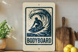 a surfboard with a wave design, accompanied by the text "BODYBOARD" on a wooden sign.