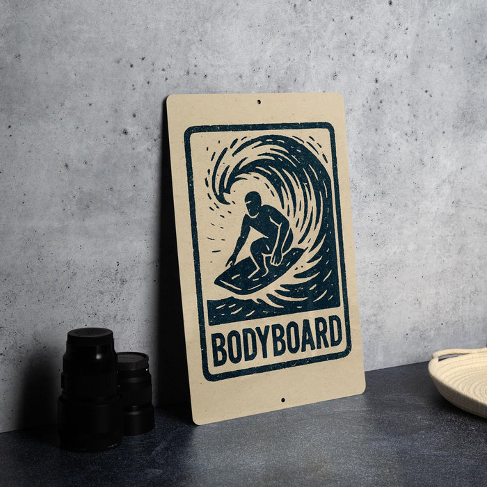 a sign with a graphic of a surfer riding a wave, accompanied by the text "BODYBOARD".