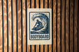 A sign with the word "BODYBOARD" printed on it, featuring a silhouette of a surfer riding a wave.
