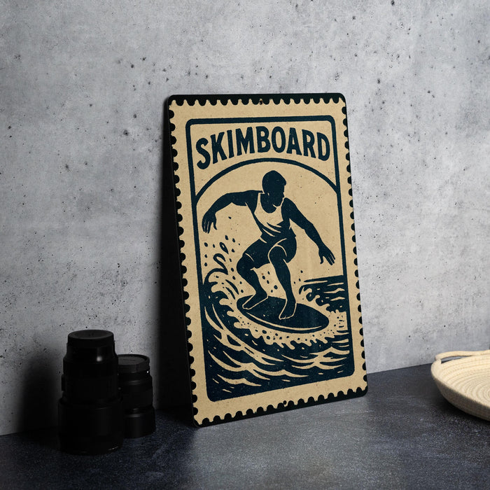 A metal sign with a graphic of a surfer on a wave, along with the text "SKIMBOARD" and a stamp-like border.