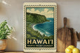 A framed illustration of a scenic coastal landscape with a cliff overlooking the ocean, surrounded by lush greenery, is displayed on a wall.