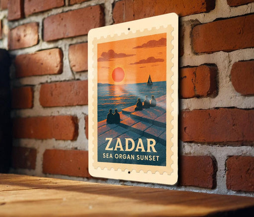 A vintage-style poster of Zador, a coastal town in Spain, depicting a sunset over the sea with silhouetted figures sitting on a pier.