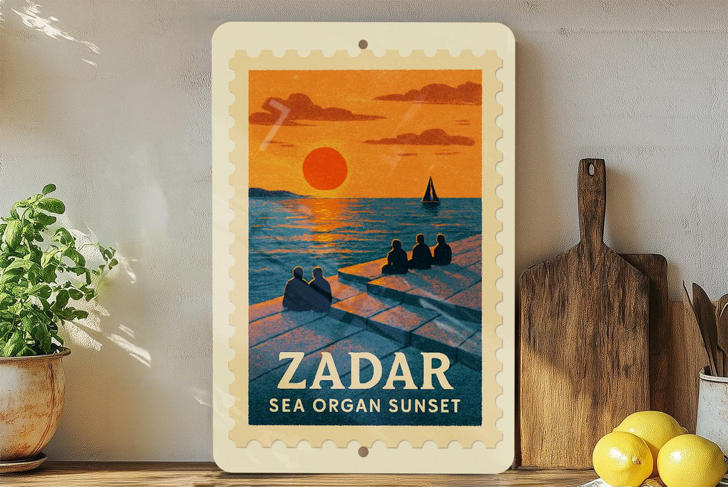 A vintage-style poster of a sunset over the sea, featuring silhouettes of people sitting on a pier. The poster is framed and displayed on a shelf, with a potted plant and a wooden cutting board visible in the background.