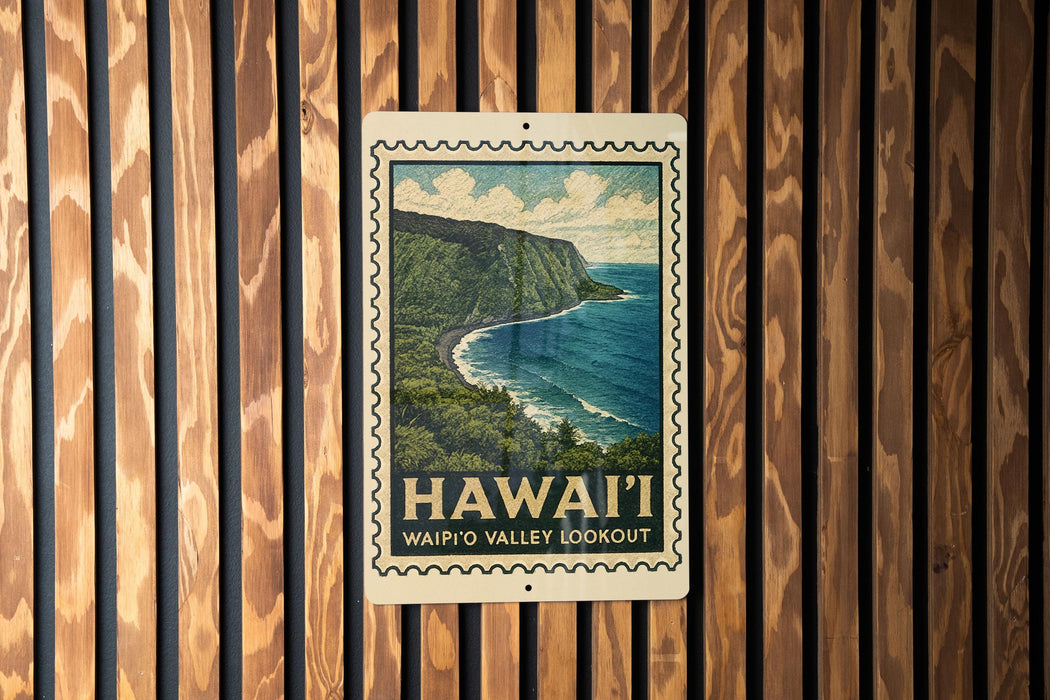 A framed poster of Waipio Valley overlooking the ocean, mounted on a wooden wall.