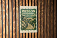 A sign for Oregon Dune Boardwalk is displayed on a wooden wall.