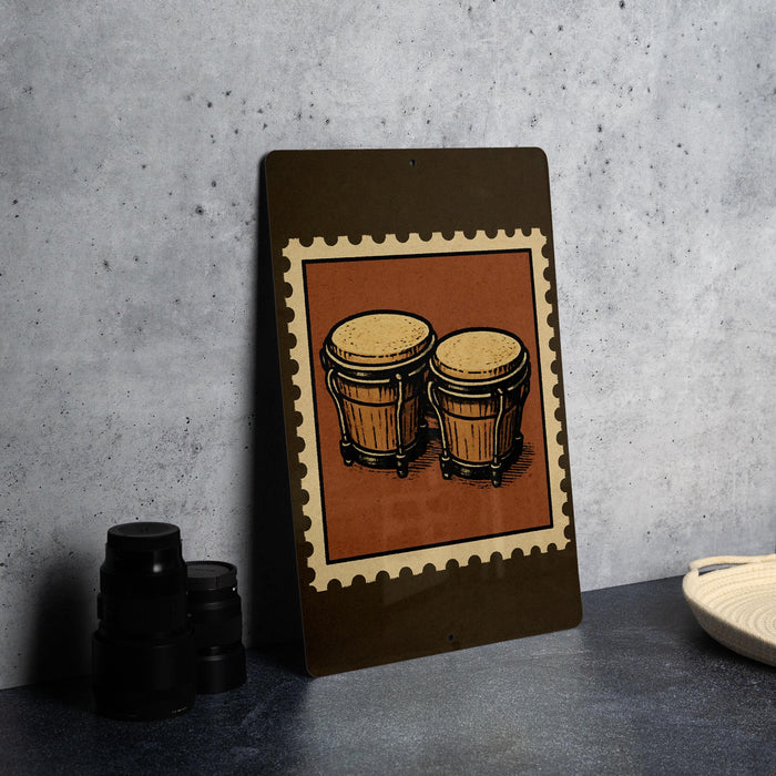 A framed illustration of two drums is displayed on a wall, with a stack of black camera lenses and a white dish visible to the side.