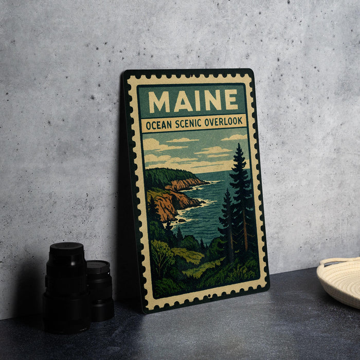 A framed poster of the Maine Ocean Scenic overlook, featuring a scenic landscape with a rocky coastline, pine trees, and the ocean.