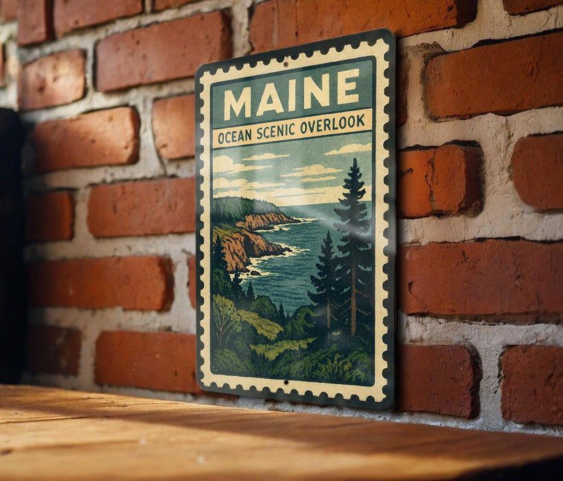 A vintage-style metal sign with the text "MAINE OCEAN SCENIC OVERLOOK" is displayed on a brick wall, depicting a scenic coastal landscape.