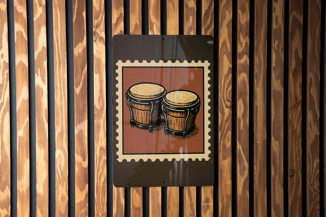 A framed image of two conga drums is displayed on a wooden wall.