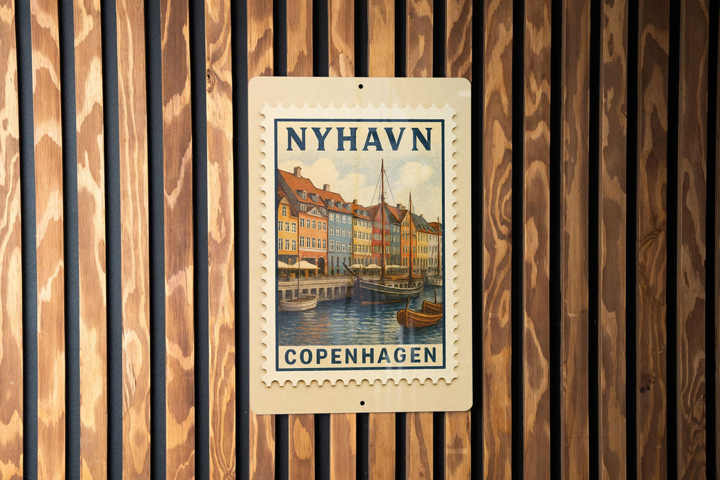 A wooden wall with a postage stamp featuring a colorful illustration of a cityscape and boats, mounted on it.