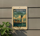 A sign for the Massachusetts Historic Waterfronts, featuring a lighthouse and a sailboat, is displayed on a wall.