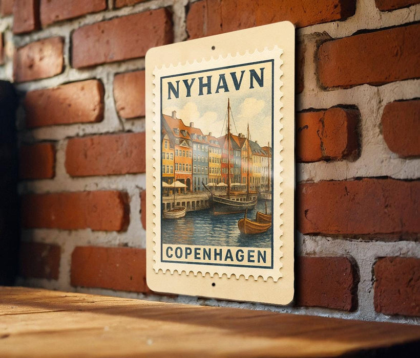 A vintage postage stamp featuring a cityscape of Copenhagen, Denmark, hanging on a brick wall.