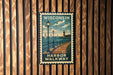 A vintage-style poster of the Harbor Walkway in Wisconsin, featuring a wooden walkway, lampposts, and sailboats on the water.