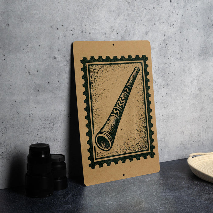 a brown paper sign with a black and white illustration of a horn or trumpet, placed on a gray countertop next to some black camera lenses.