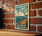 A vintage-style metal sign with a lighthouse and a wooden walkway, mounted on a brick wall.