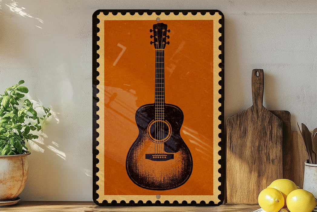a framed picture of an acoustic guitar on a shelf, with a potted plant to the left and a wooden cutting board to the right.