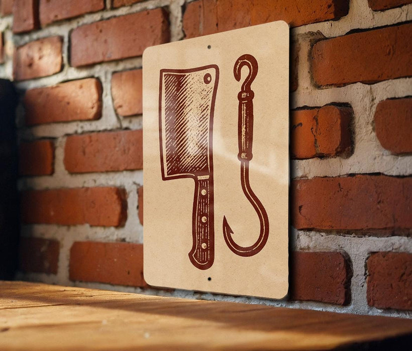 a sign with a picture of a knife and a hook on it, mounted on a brick wall.