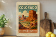 A framed vintage-style stamp depicting the scenic landscape of the Red Rock Country in Colorado.