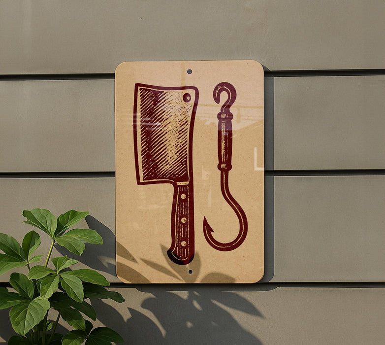a sign with a butcher knife and a hook, mounted on a wall.