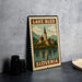 A framed poster of Lake Bled, a famous landmark in Slovenia, is displayed on a table.