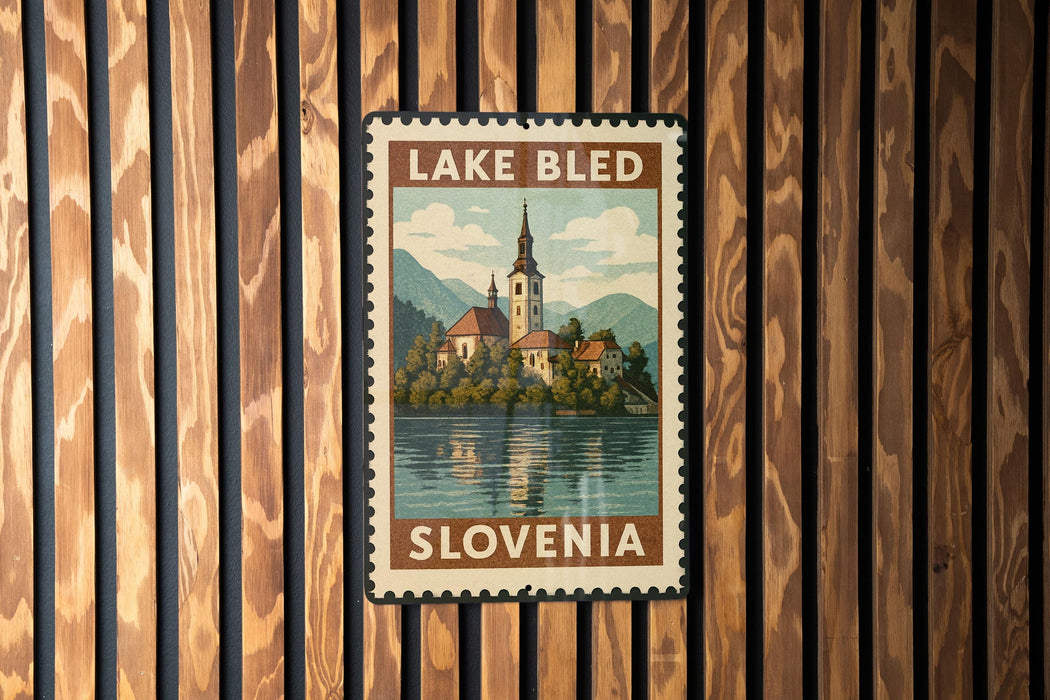 A vintage postage stamp from Slovenia depicting a church and a lake, hanging on a wooden wall.