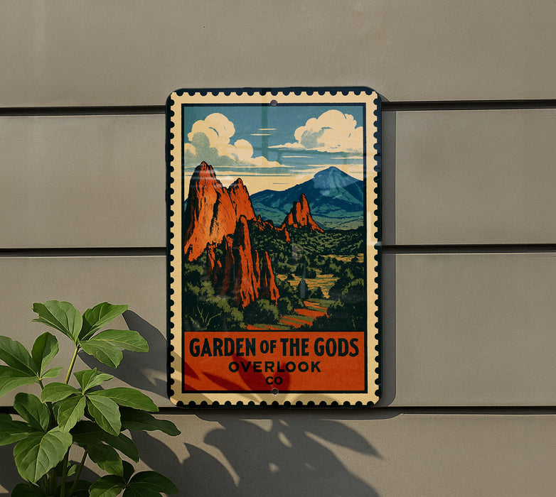 A vintage-style metal sign with a mountain landscape and clouds, mounted on a wall.