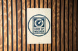 A sign with the text "COIN-OP WASHER" is displayed on a wooden wall.