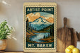 A vintage-style wooden sign with a mountain landscape and a river, featuring the text "ARTIST POINT" and "MT. BAKER". The sign is displayed on a shelf next to a potted plant and a wooden cutting board.
