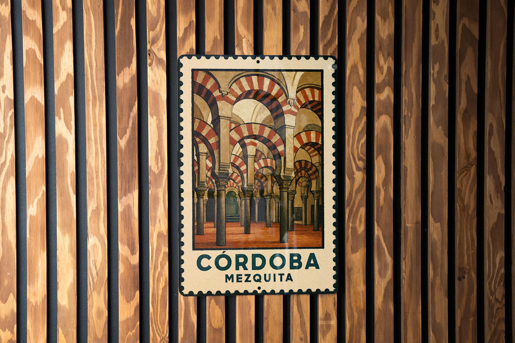 A framed poster of the Córdoba Mosque in Spain, featuring the intricate architecture of the mosque's arches and columns.