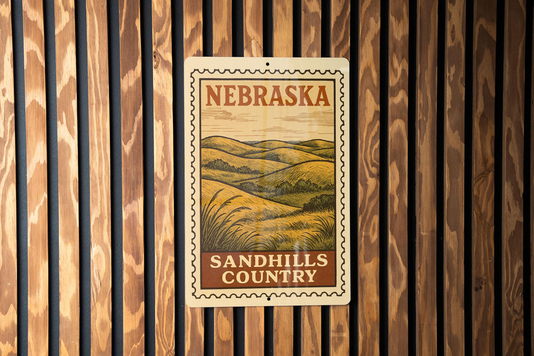 A metal sign with the text "NEBRASKA SANDHILLS COUNTRY" is displayed on a wooden wall.