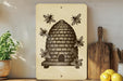 a beehive with bees on a wooden surface, surrounded by kitchen utensils and a potted plant.
